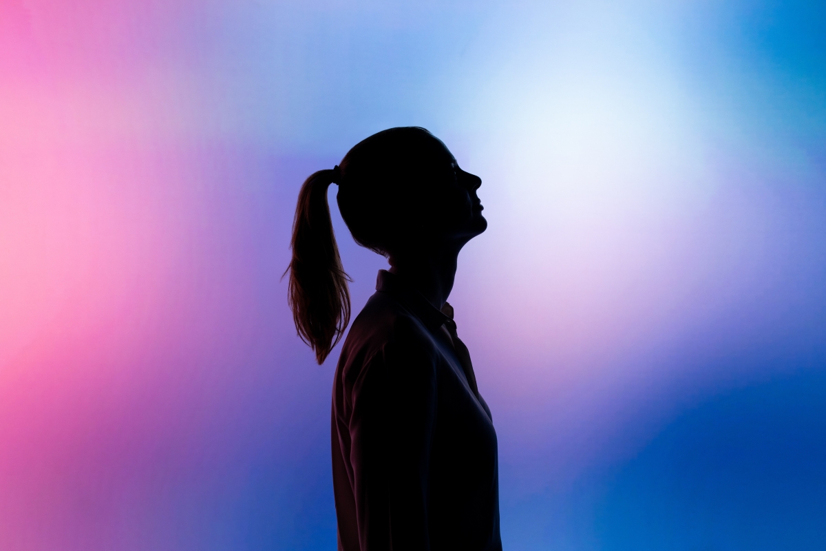 Woman standing in front of neon lights